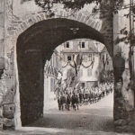 Blick durch den Ziegelturm auf eine Gruppe der Hitler-Jugend die durch die Stadt ziehen (Anlass unbekannt)